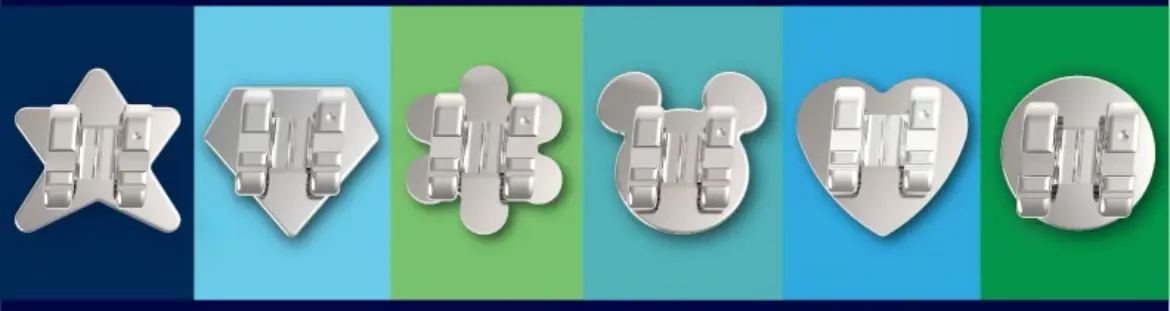 At Holt Orthodontics in Twinsburg, OH, six silver shapes—star, diamond, flower, mouse head, heart, and circle—on blue-green stripes from WildSmiles Braces.