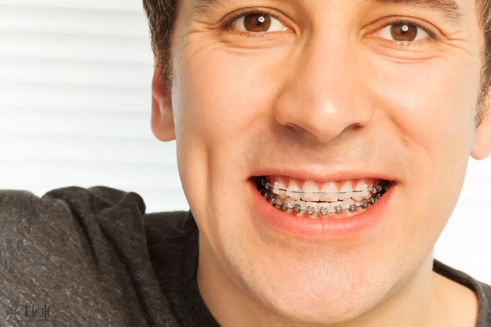 happy young man with metal braces - Overbite vs Underbite in Twinsburg, OH