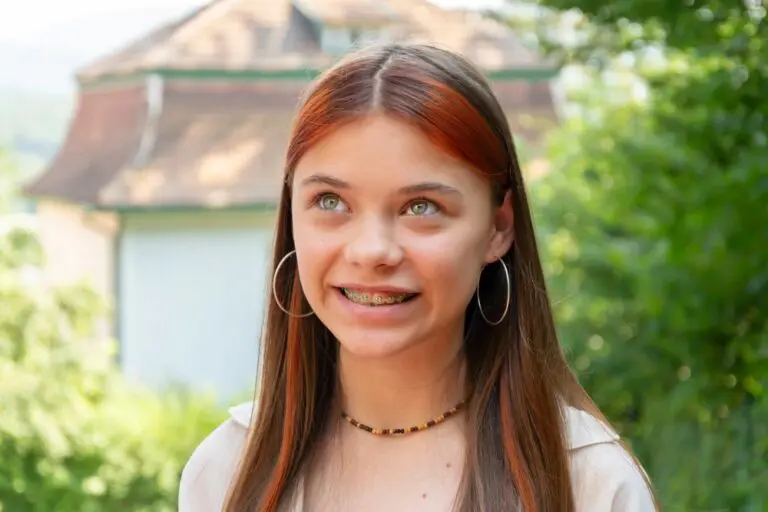 beautiful teenage girl metal braces smiles street - How to Get Braces Glue Off Teeth in Twinsburg, OH