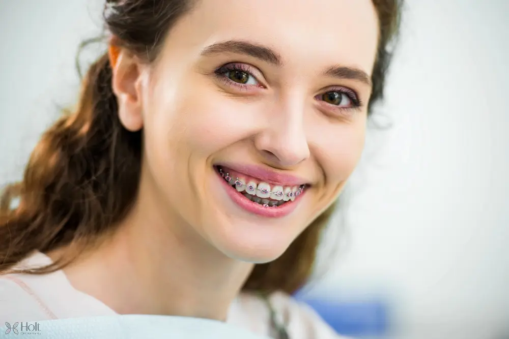 close happy woman metal braces teeth smiling dental clinic - How to Get Braces Glue Off Teeth in Twinsburg, OH
