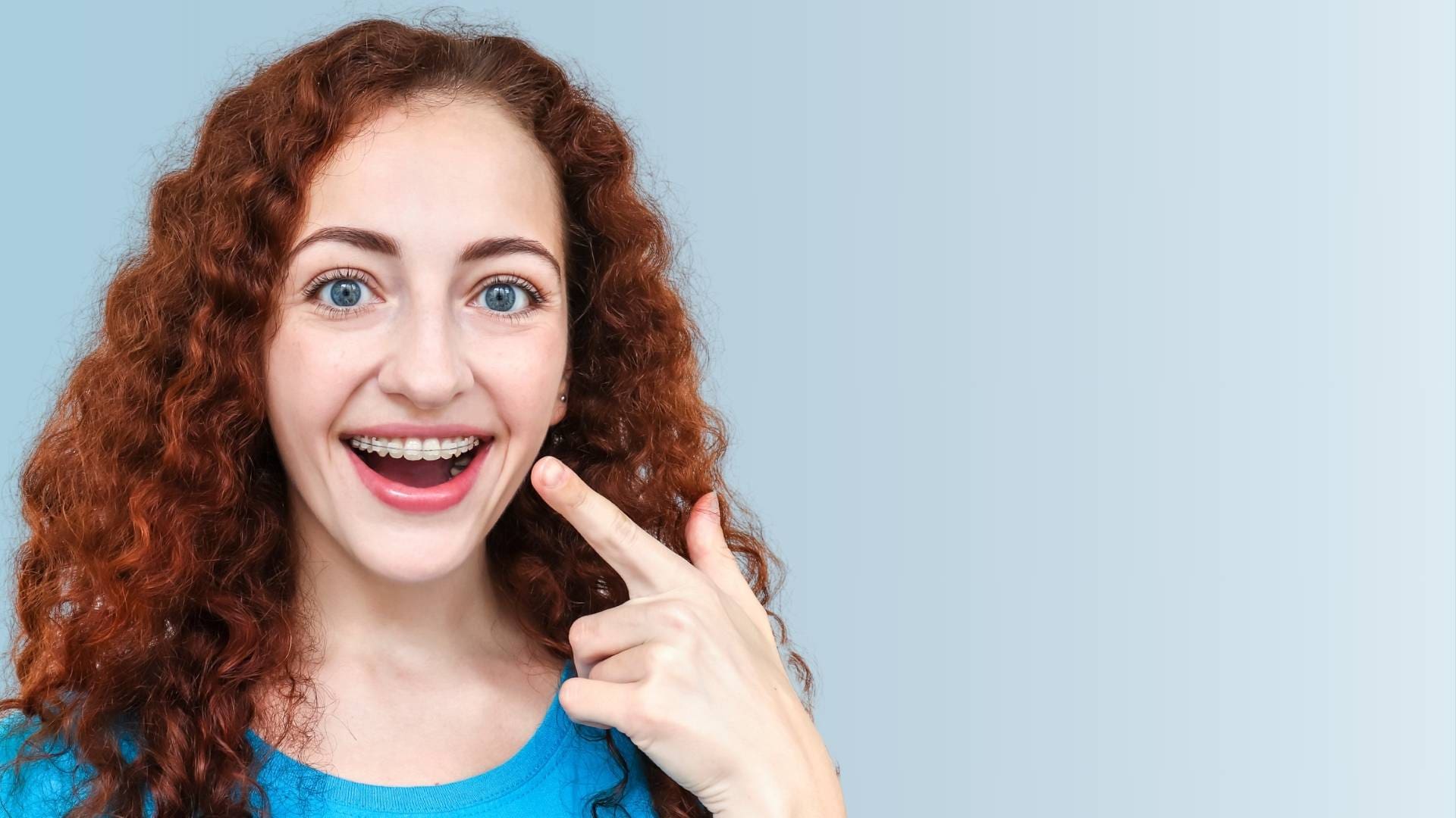 At Holt Orthodontics in Twinsburg, OH, a woman displays braces for explaining orthodontic insurance plans to other patients.