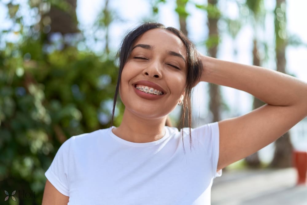 young arab woman with metal braces breathing closed eyes street - How Long Do Braces Take in Twinsburg, OH